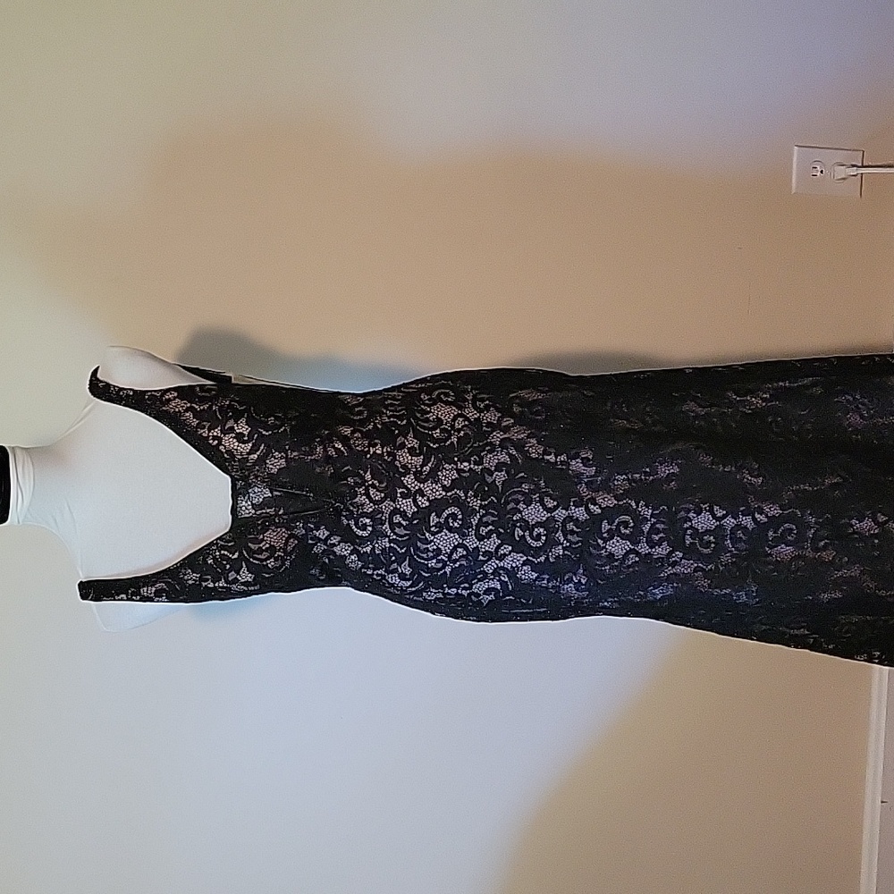 Formal dress in black with nude lining, plunging neck and back. Beaded lace